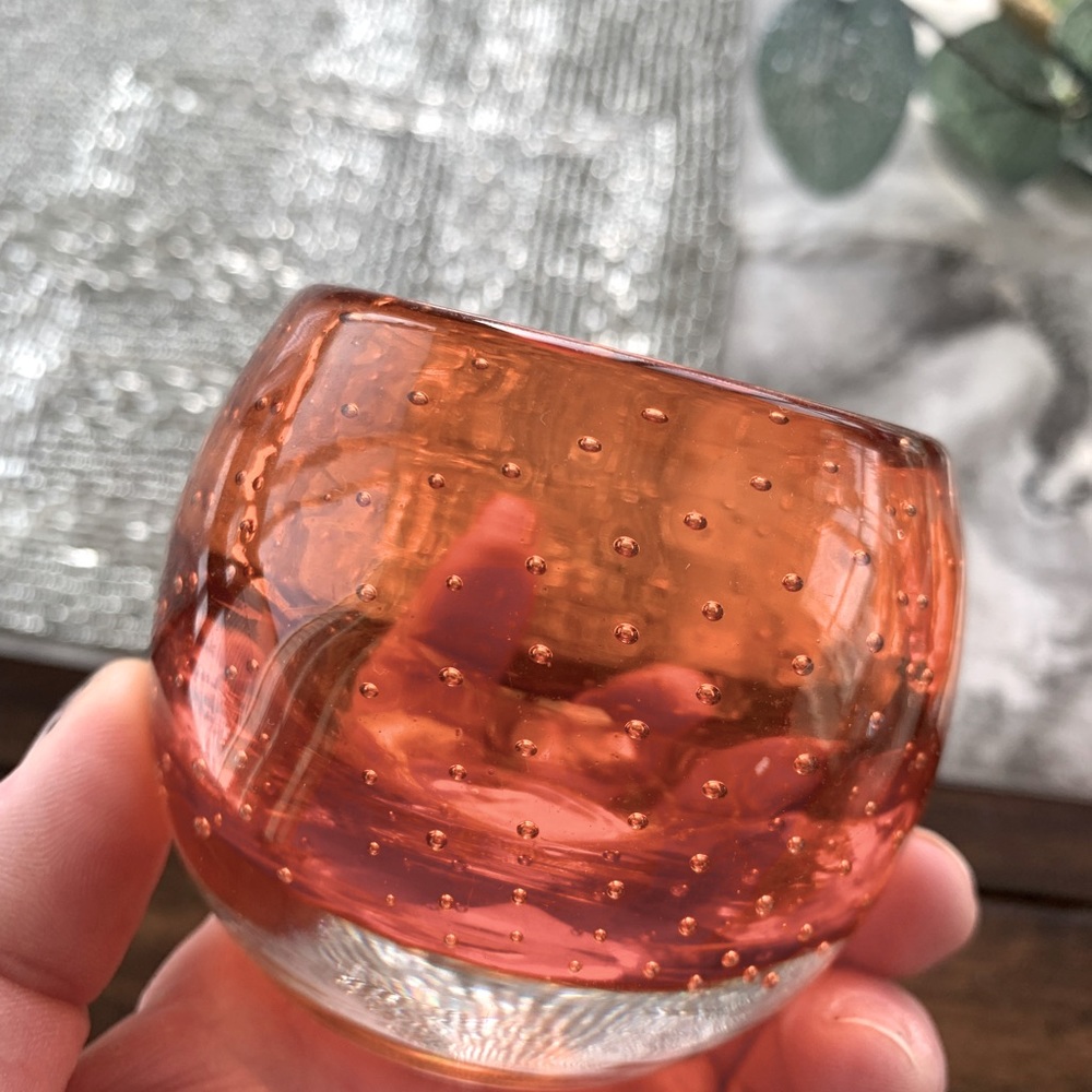 Two orange colored tea light candle holders